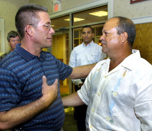 Methuen: Gordy Dibler of Michigan, left, and Andy Jimenez of Lawrence hug as they meet each other for the first time. Dibler's stepson, U.S. Army Pvt. Byron Fouty, 19, of Michigan and Jimenez's son, U.S. Army Spec. Alex Jimenez of Lawrence, were kidnapped during an attack on their army unit in Iraq in May. They are still missing. Photo by Carl Russo/Eagle-Tribune